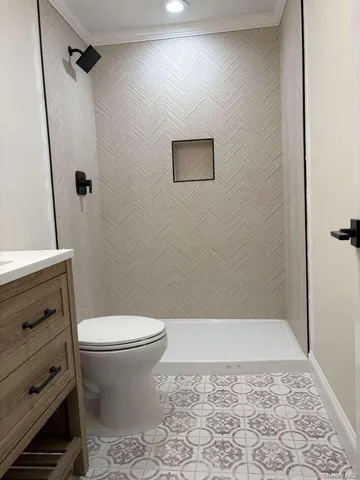 a bathroom with a toilet and a shower