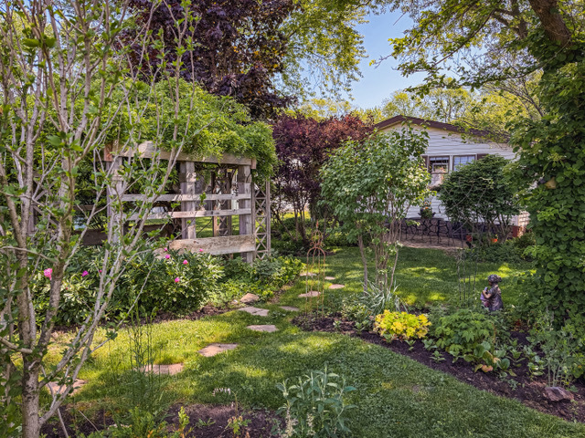 38569 North Sheridan Road, Unit 390 Beach Park, IL 60099 - Photo 22 of 28 a backyard of a house with lots of green space and lake view