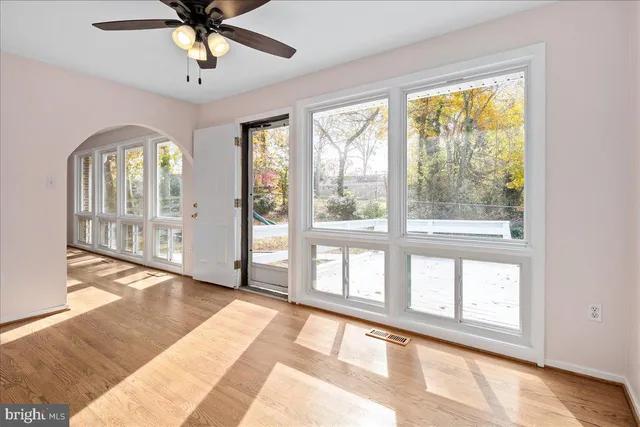 a view of an empty room with a window and a livingroom
