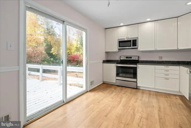 a kitchen with stainless steel appliances a stove sink and microwave