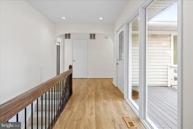 a view of a hallway with wooden floor