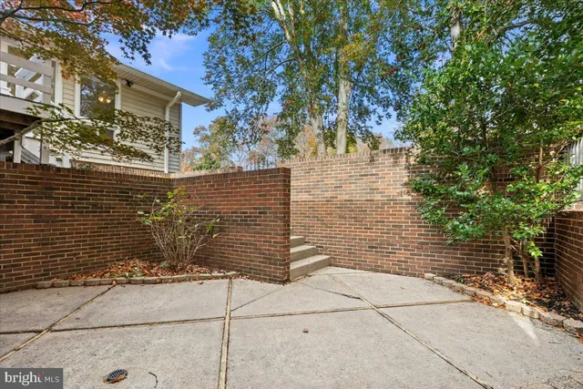 a view of a wooden door and brick wall