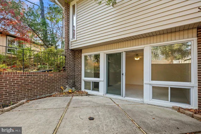 an empty room with chandelier fan