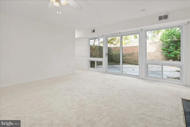 an empty room with windows and closet