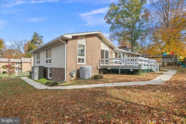 a aerial view of a house with yard porch and furniture