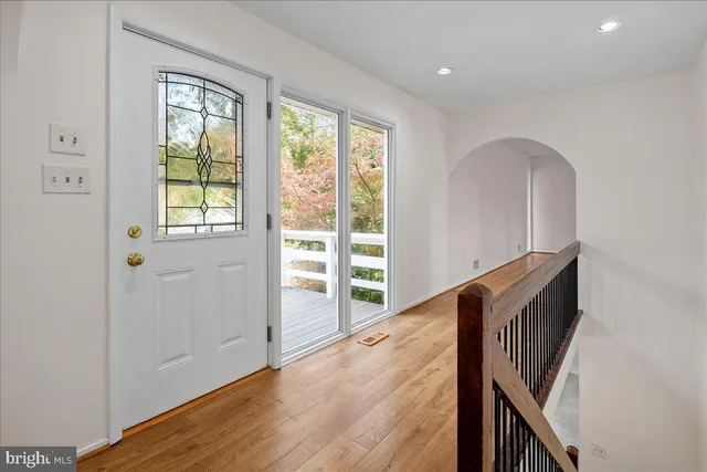 a view of an entryway with wooden floor and stairs
