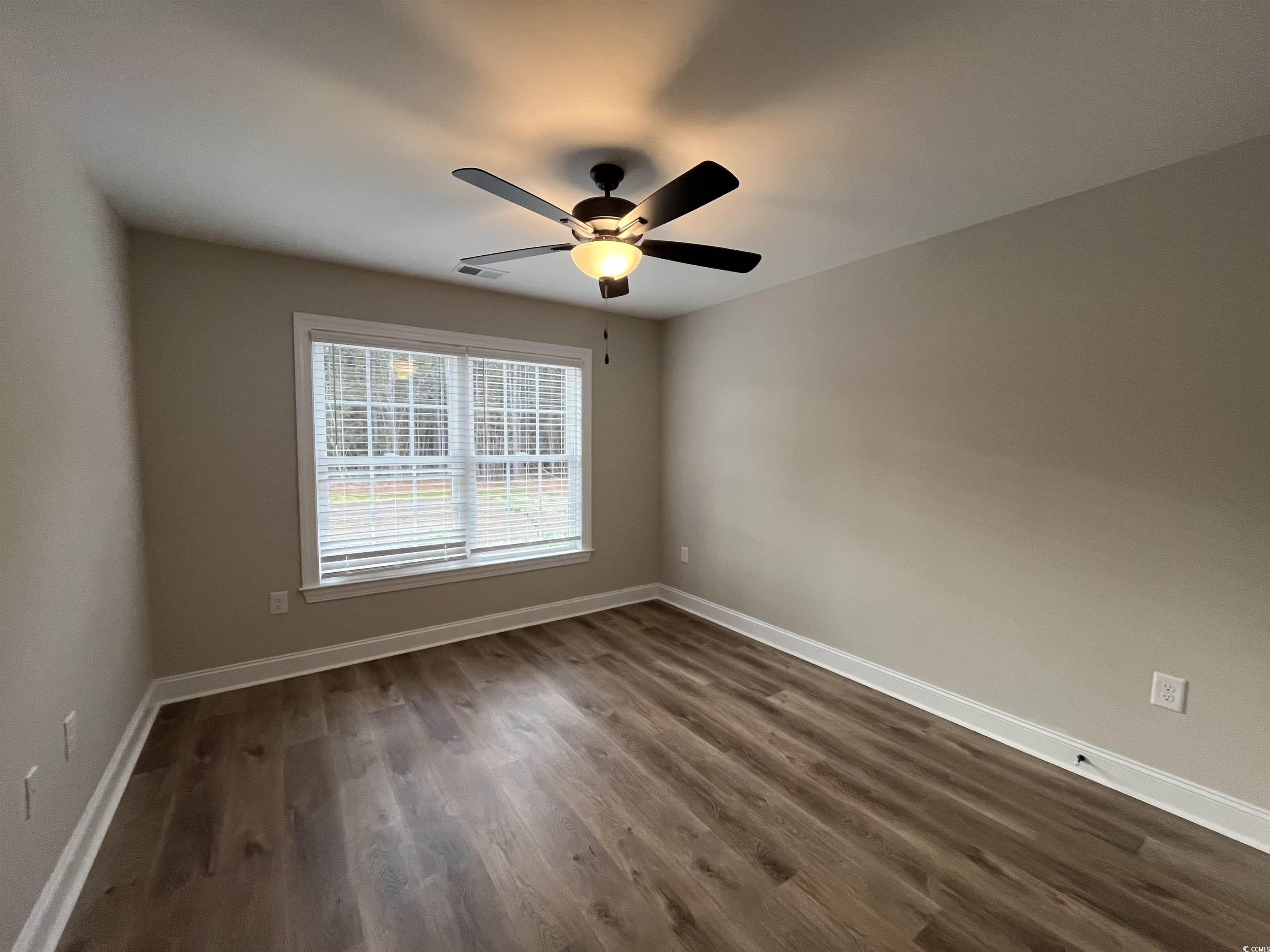 2584 Moores Mill Road Aynor, SC 29511 - Photo 11 of 14 Spare room featuring dark wood-type flooring and ceiling fan