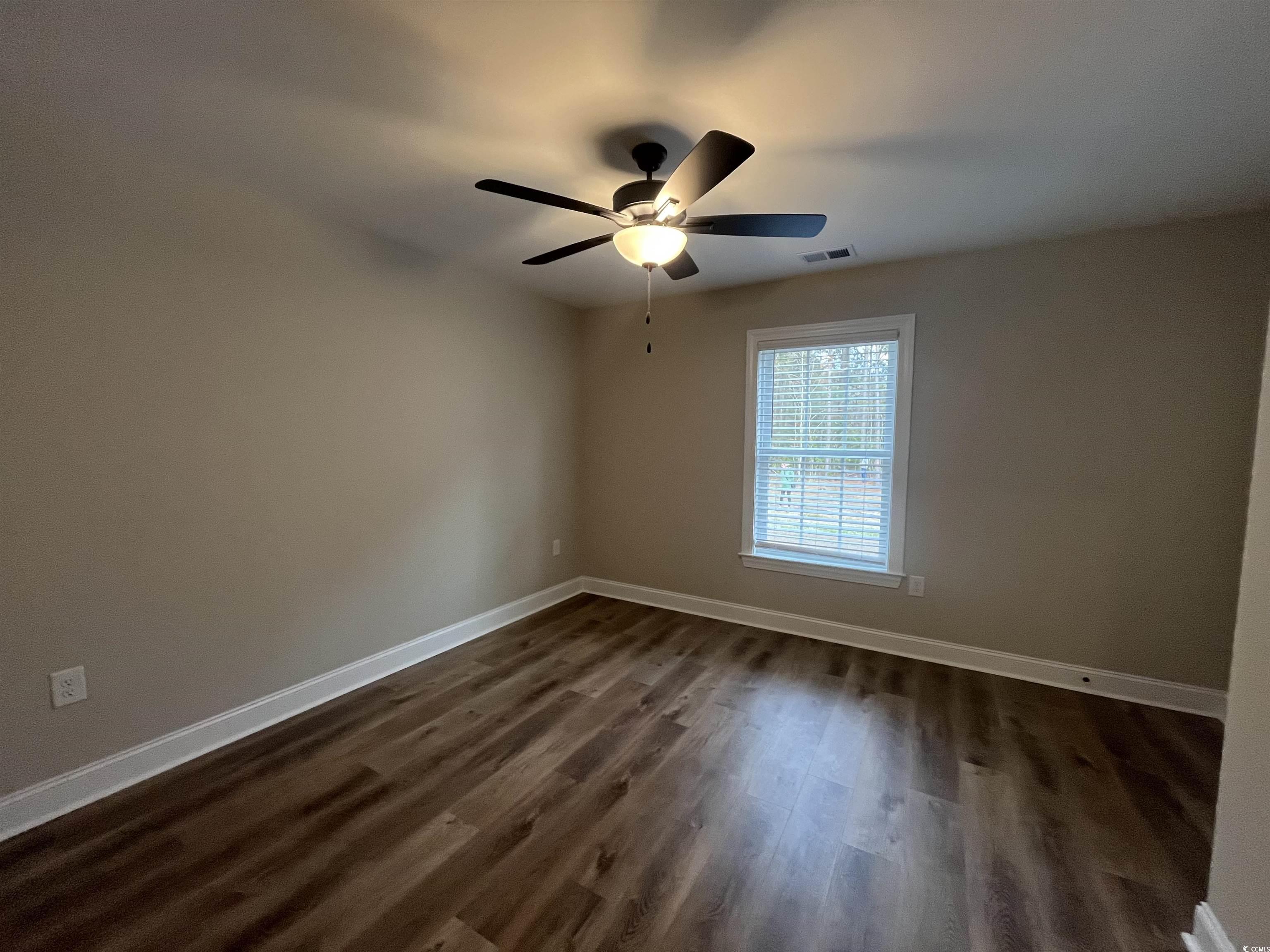2584 Moores Mill Road Aynor, SC 29511 - Photo 12 of 14 Spare room with dark wood-style floors and a ceiling fan