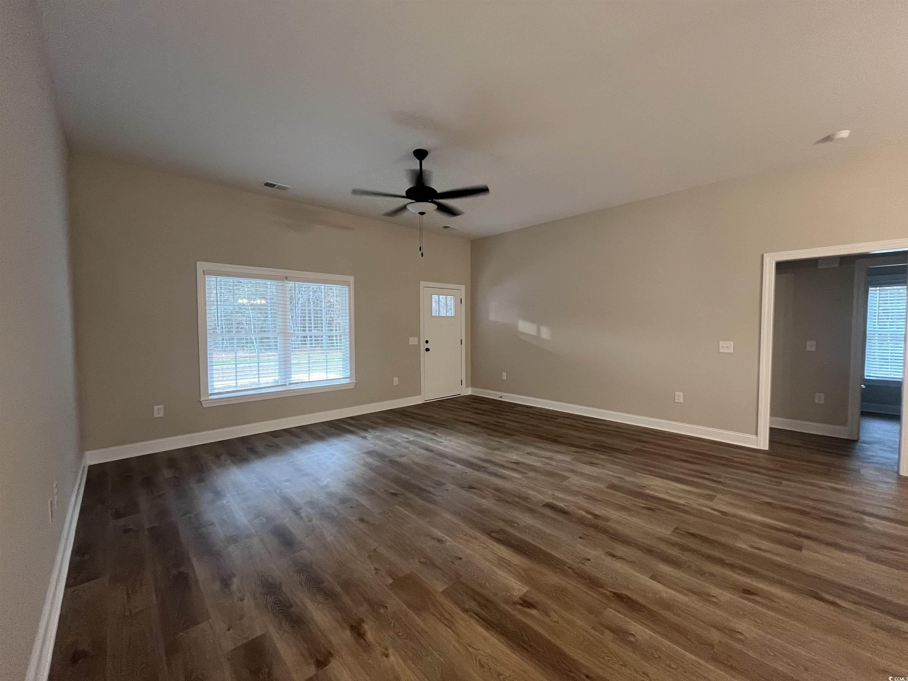 2584 Moores Mill Road Aynor, SC 29511 - Photo 5 of 14 Unfurnished living room with dark wood-style floors and a ceiling fan