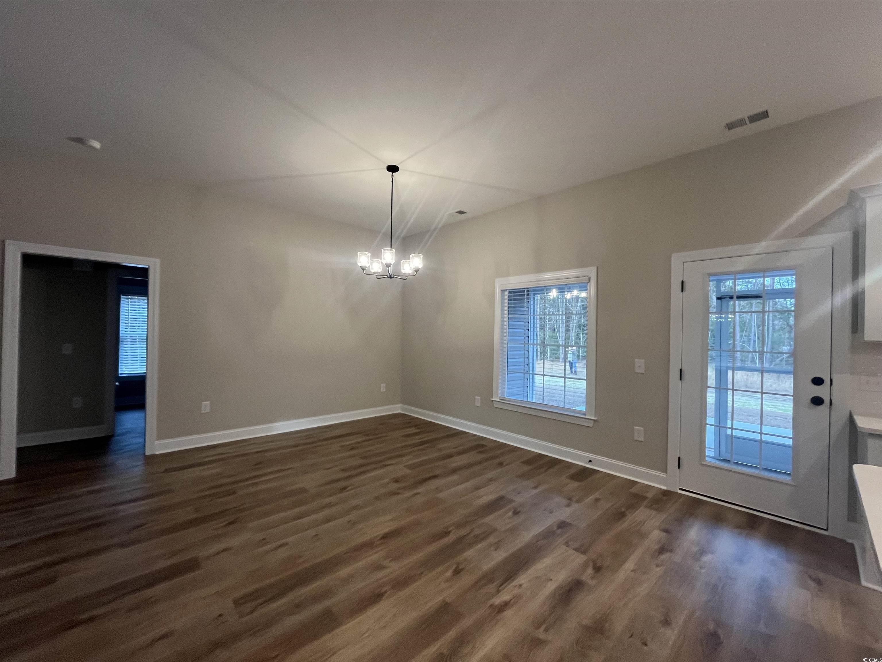 2584 Moores Mill Road Aynor, SC 29511 - Photo 7 of 14 Unfurnished dining area with a chandelier and dark wood finished floors