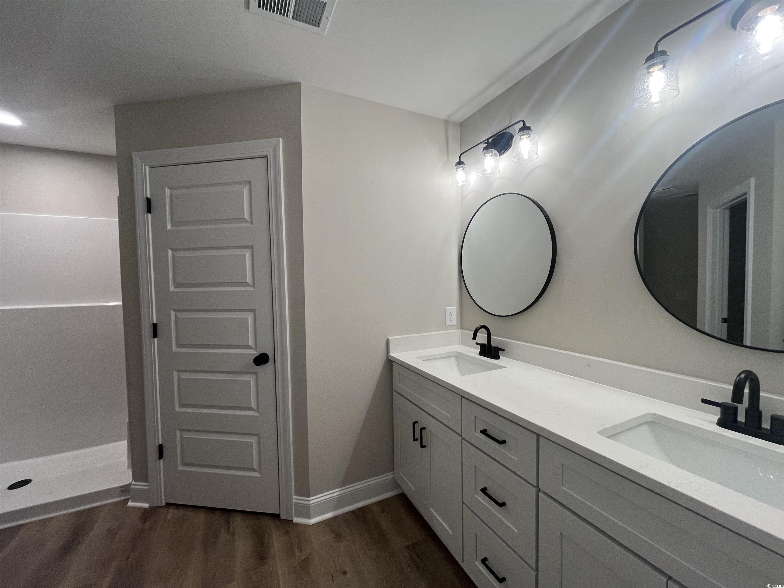 2584 Moores Mill Road Aynor, SC 29511 - Photo 9 of 14 Bathroom featuring double vanity and dark wood-style flooring