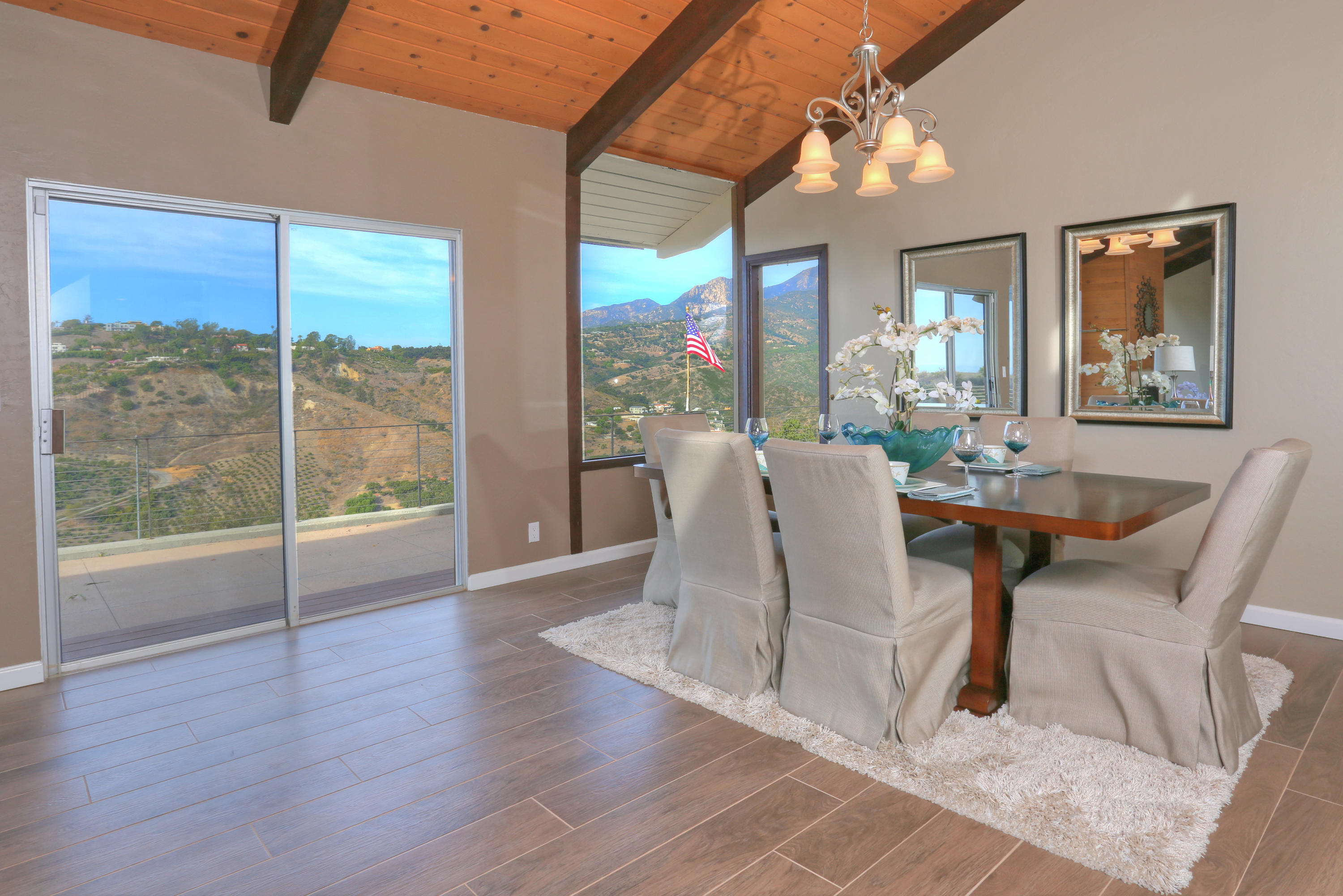 64 Ridge View Road Santa Barbara, CA 93108 - Photo 3 of 18 a dining room with wooden floor fan and a floor to ceiling window