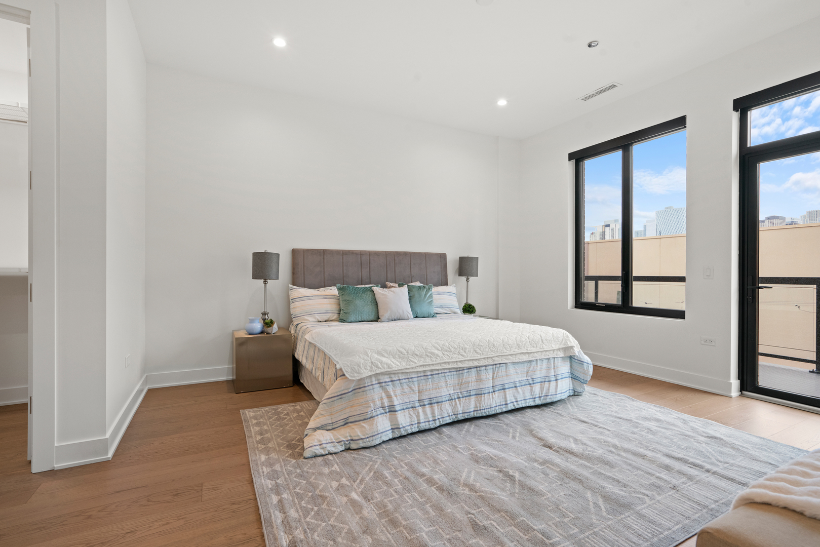 313 South Racine Avenue, Unit 4B Chicago, IL 60607 - Photo 15 of 33 a bedroom with a large bed and a large window