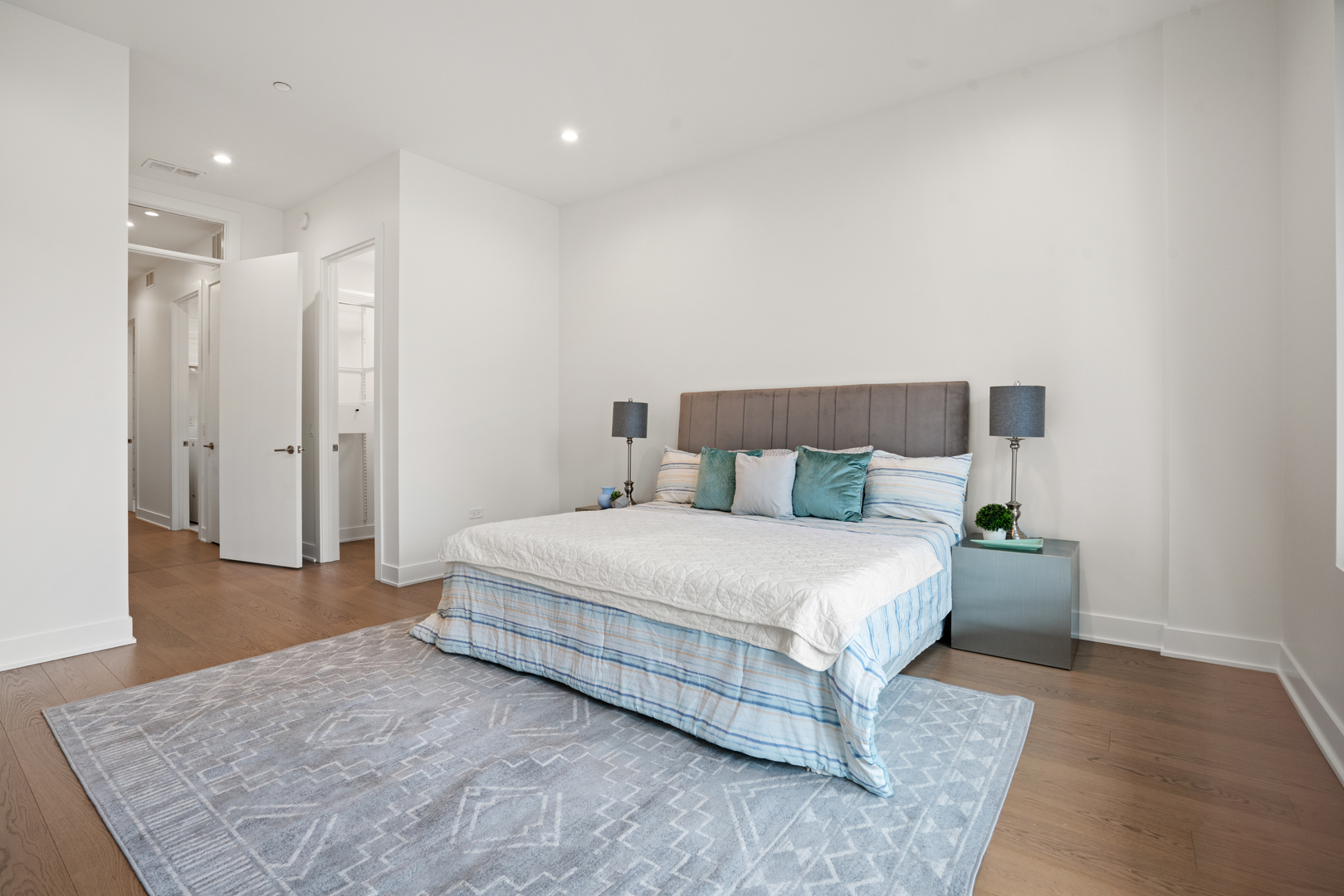 313 South Racine Avenue, Unit 4B Chicago, IL 60607 - Photo 19 of 33 a bedroom with a bed and wooden floor