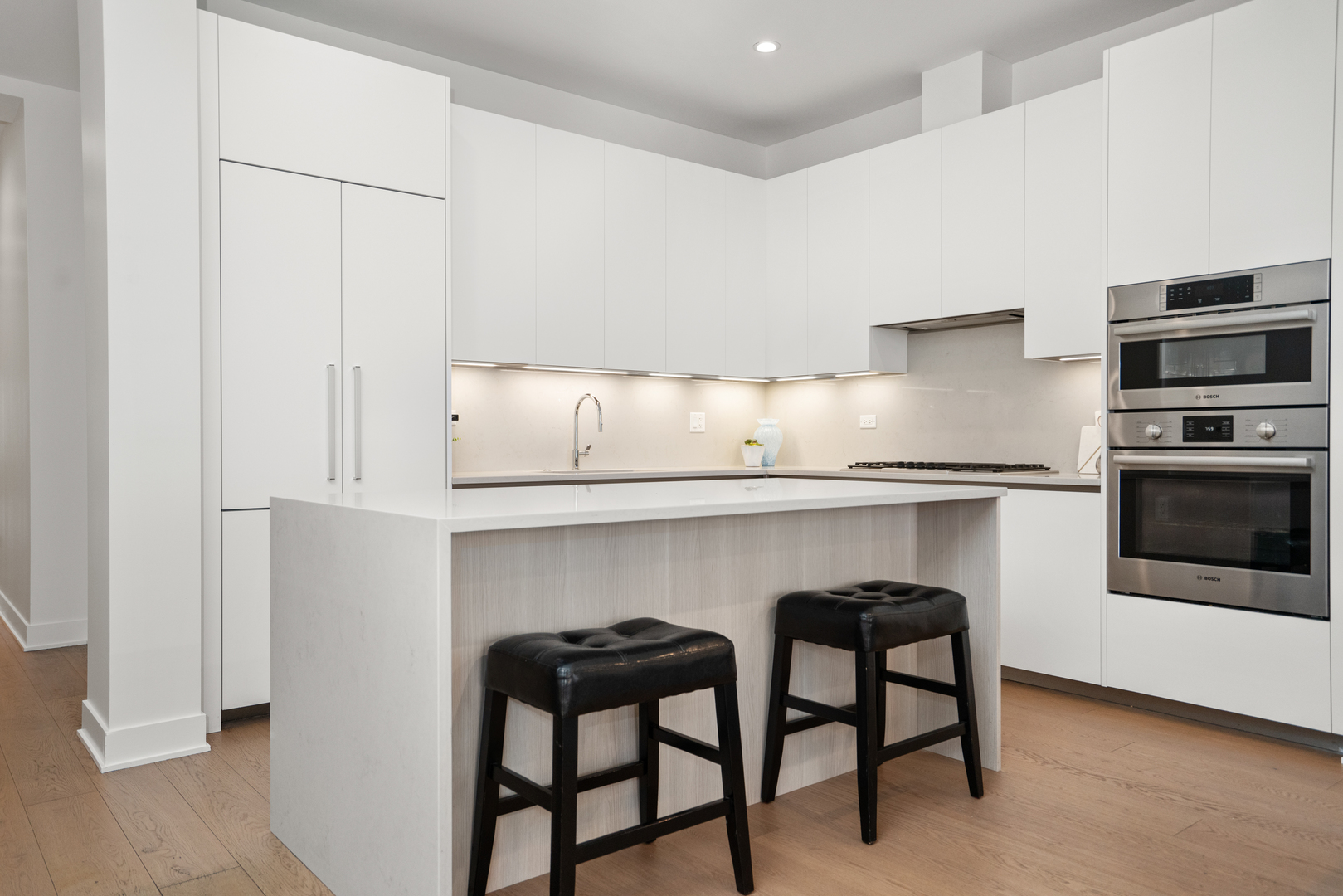 313 South Racine Avenue, Unit 4B Chicago, IL 60607 - Photo 2 of 33 a kitchen with stainless steel appliances granite countertop a table chairs sink and cabinets