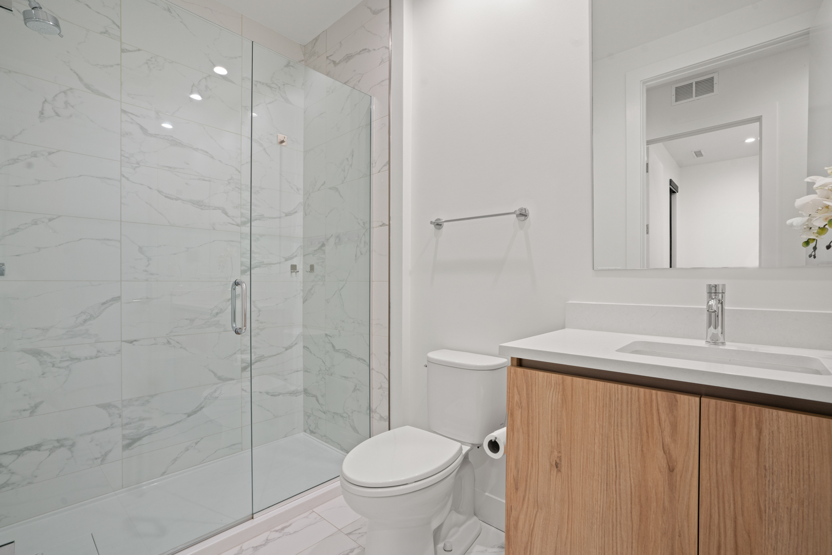 313 South Racine Avenue, Unit 4B Chicago, IL 60607 - Photo 30 of 33 a bathroom with a granite countertop sink toilet and shower