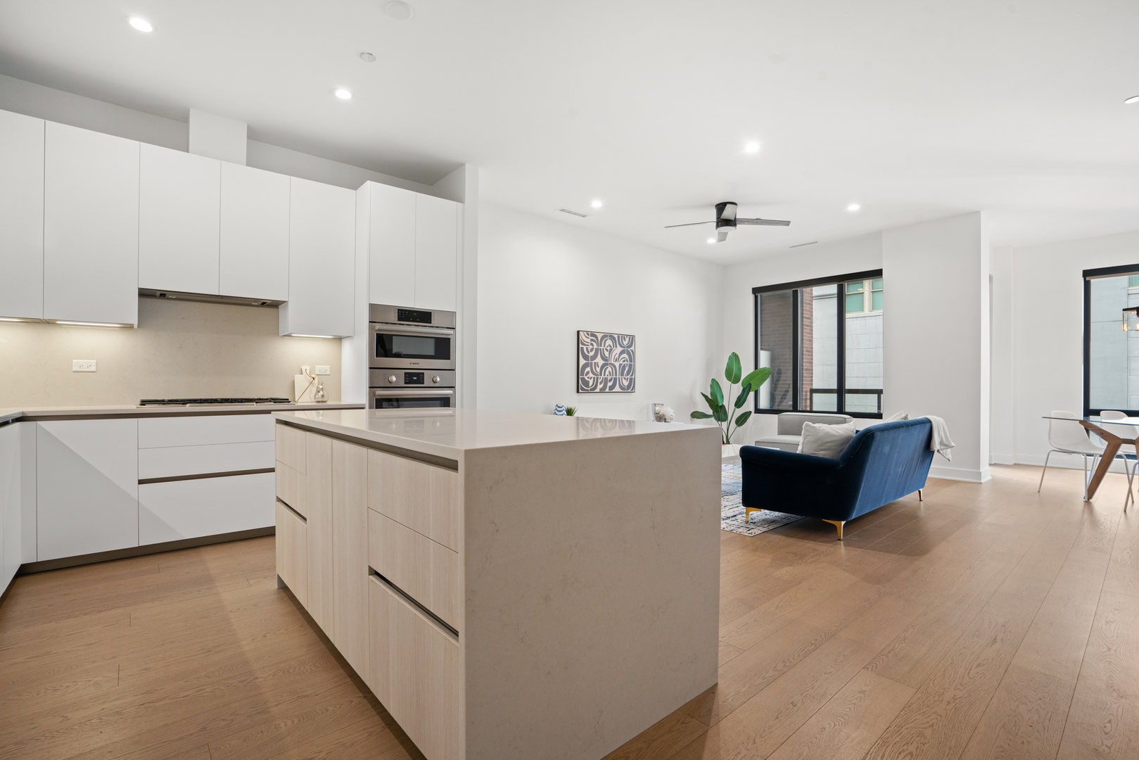 313 South Racine Avenue, Unit 4B Chicago, IL 60607 - Photo 7 of 33 a large white kitchen with a refrigerator a stove a sink and a oven