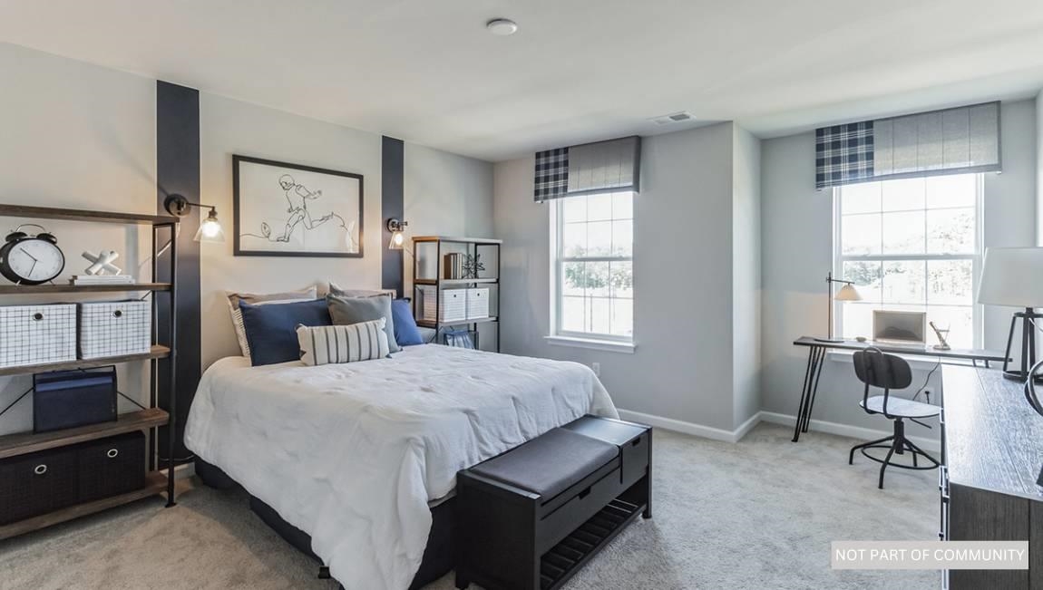 504 Scotty, Unit 1203 Rio Grande, NJ 08242 - Photo 16 of 25 a bedroom with a bed a table and chair