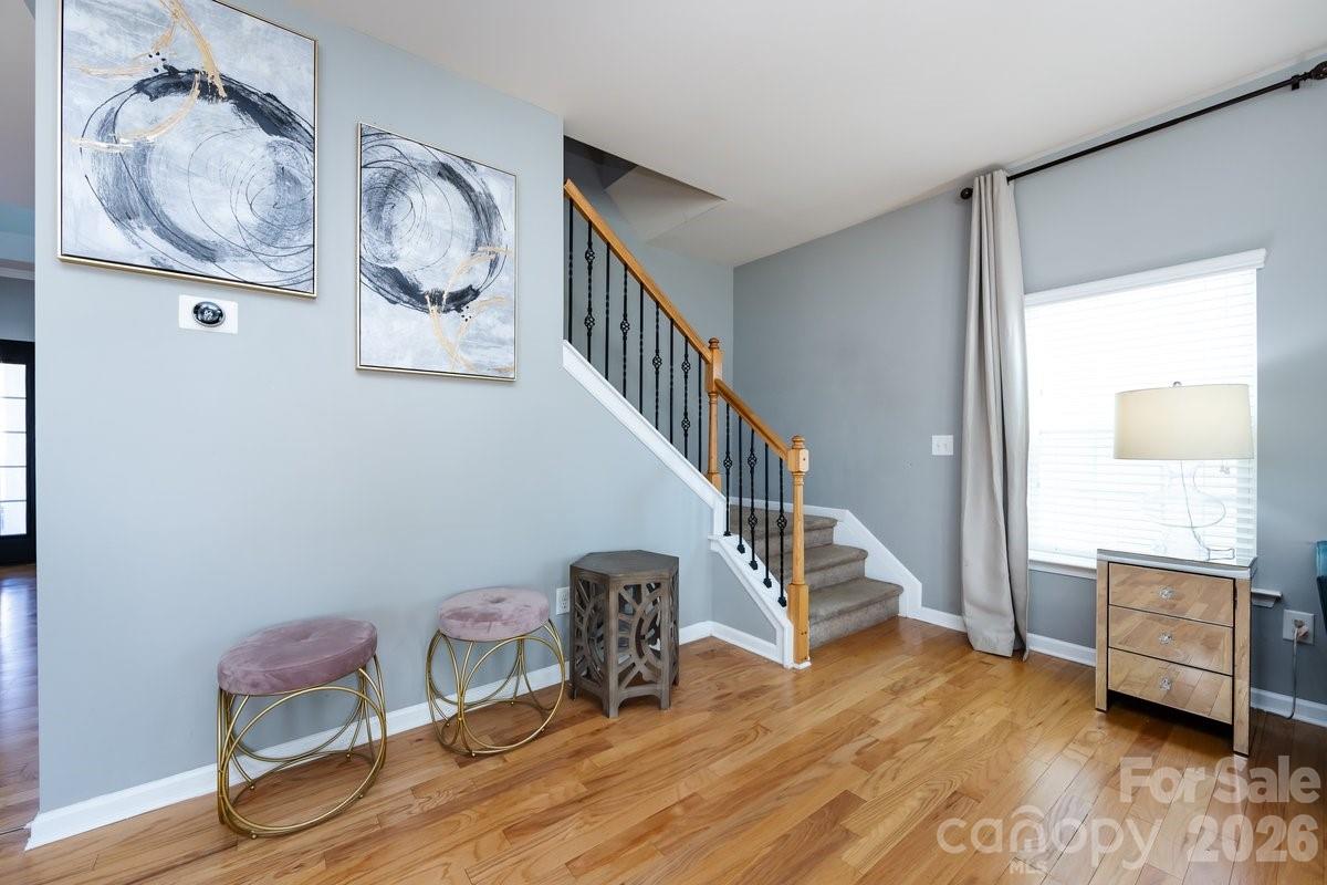 8931 Happiness Road Harrisburg, NC 28075 - Photo 16 of 27 a view of room with furniture and wooden floor