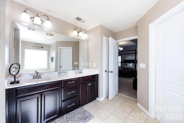 a spacious bathroom with a double vanity sink and mirror