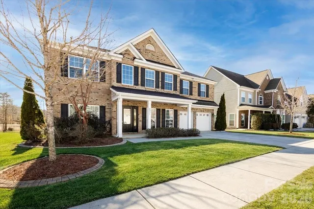 a front view of a house with a yard