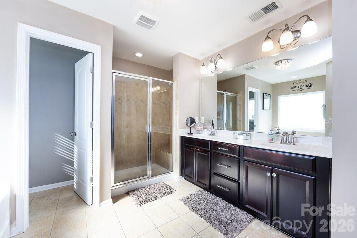 8931 Happiness Road Harrisburg, NC 28075 - Photo 21 of 27 a bathroom with a sink and a mirror