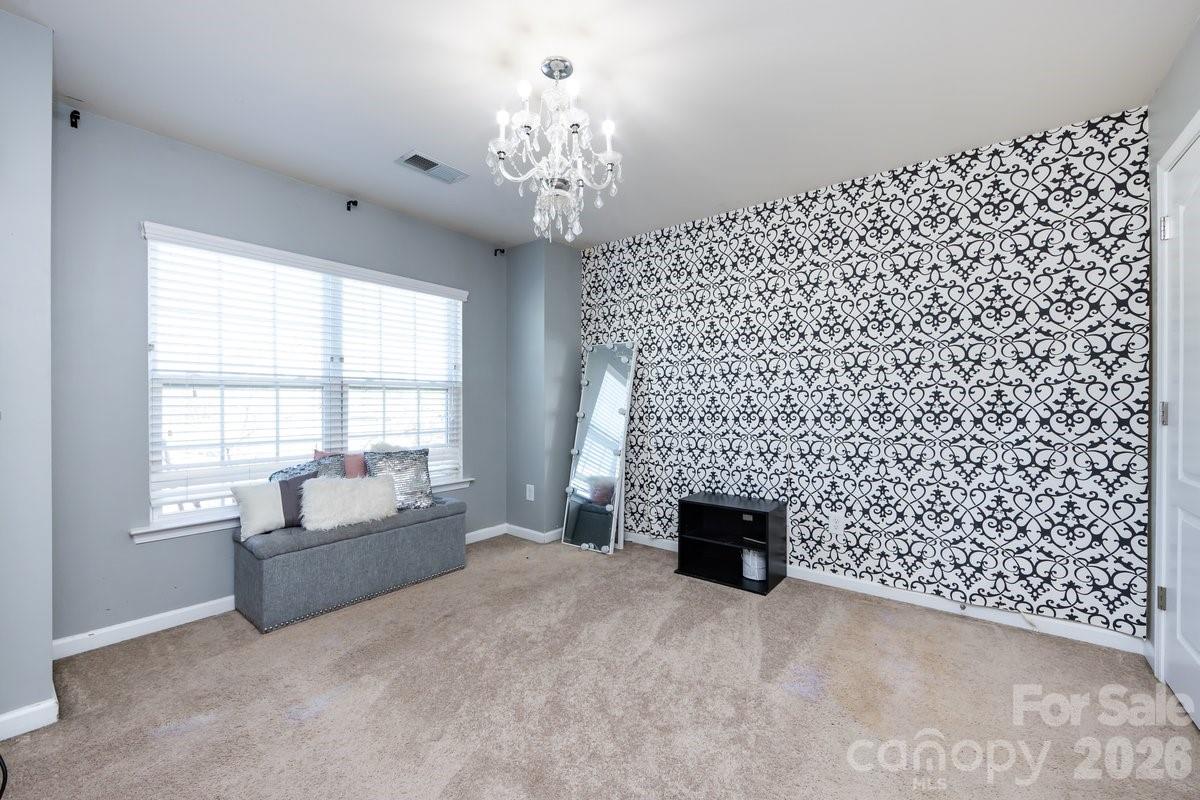 8931 Happiness Road Harrisburg, NC 28075 - Photo 23 of 27 a living room with a fireplace and a window
