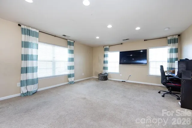 a view of a livingroom with workspace and a window