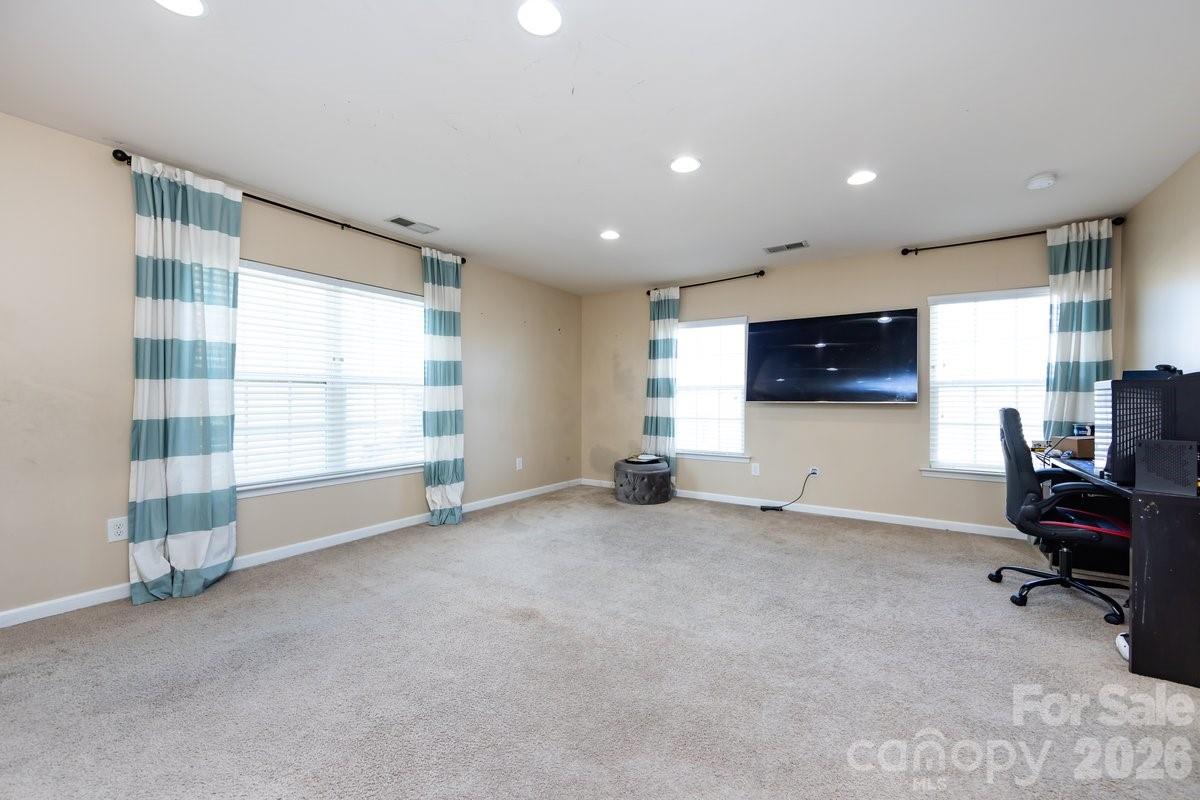 8931 Happiness Road Harrisburg, NC 28075 - Photo 24 of 27 a view of a livingroom with workspace and a window