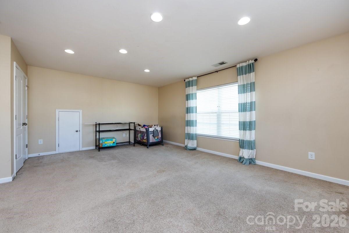 8931 Happiness Road Harrisburg, NC 28075 - Photo 25 of 27 a view of an empty room with a window