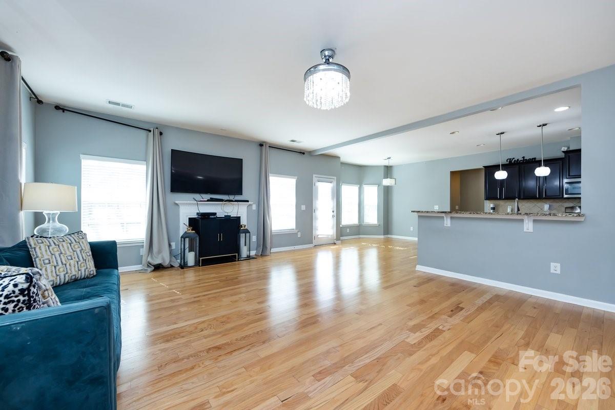 8931 Happiness Road Harrisburg, NC 28075 - Photo 7 of 27 a view of kitchen and dining room with wooden floor