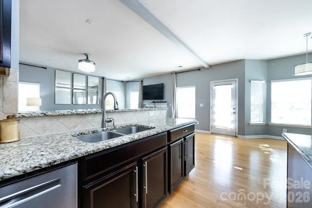 a kitchen with granite countertop a sink and a counter top space