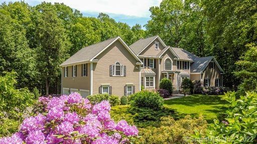 Picture Perfect. Stunning flowering plants envelope this stunning home.