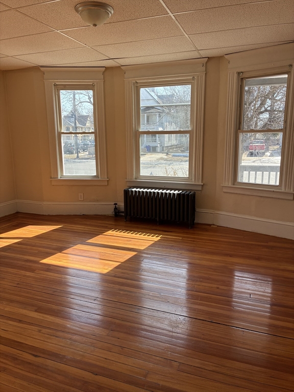 658 Sumner Avenue, Unit 1 Springfield, MA 01108 - Photo 6 of 10 an empty room with wooden floor and windows