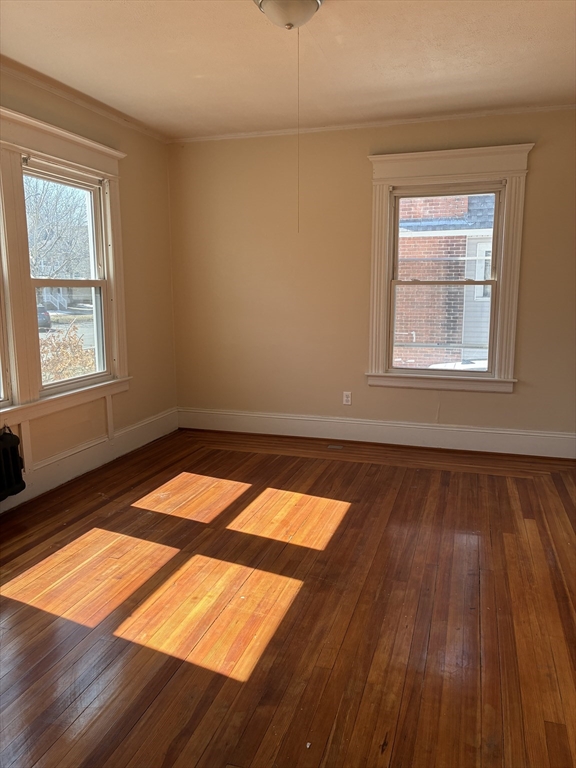 658 Sumner Avenue, Unit 1 Springfield, MA 01108 - Photo 10 of 10 an empty room with wooden floor and windows