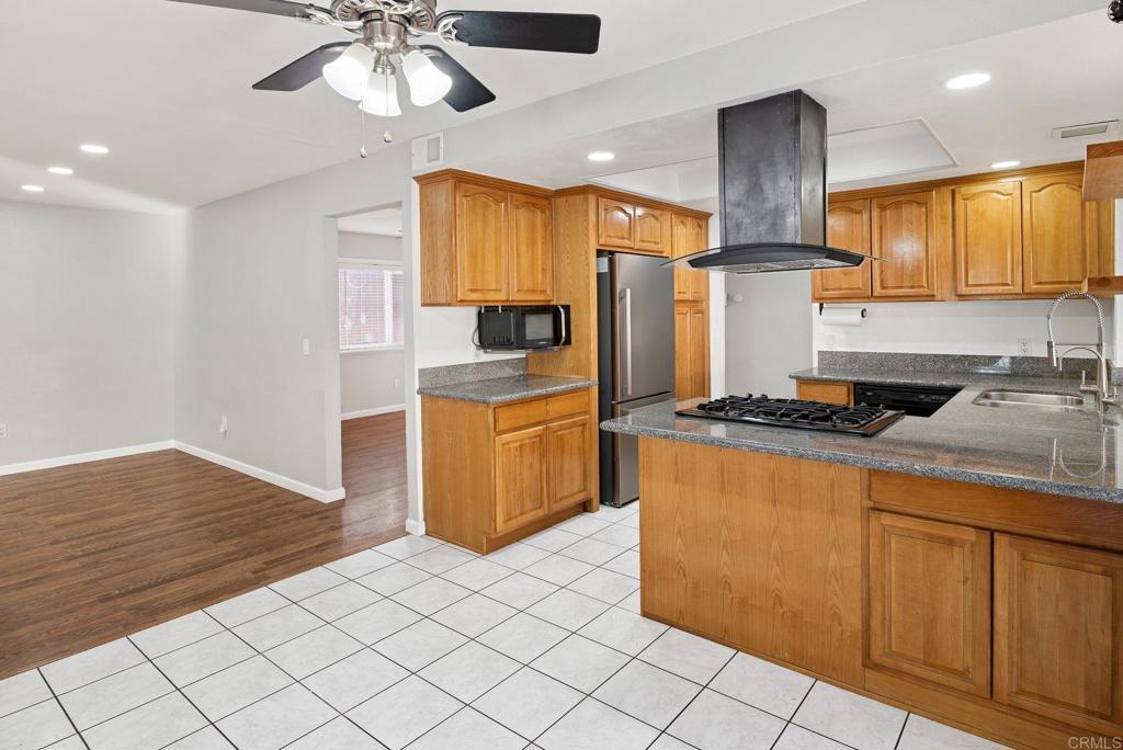 13131 Chrissy Way Lakeside, CA 92040 - Photo 13 of 30 a kitchen with stainless steel appliances granite countertop a sink a stove cabinets and wooden floor