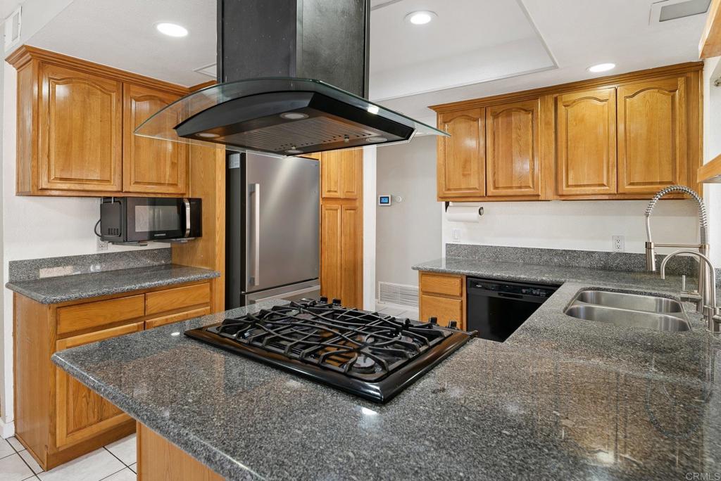 13131 Chrissy Way Lakeside, CA 92040 - Photo 14 of 30 a kitchen with stainless steel appliances granite countertop a sink stove and refrigerator