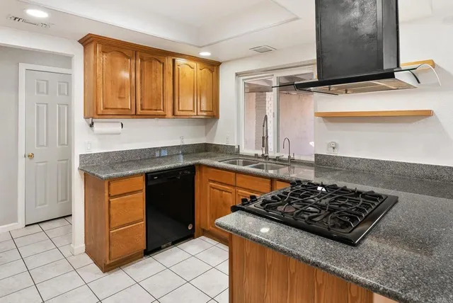 a kitchen with stainless steel appliances granite countertop a stove and a sink