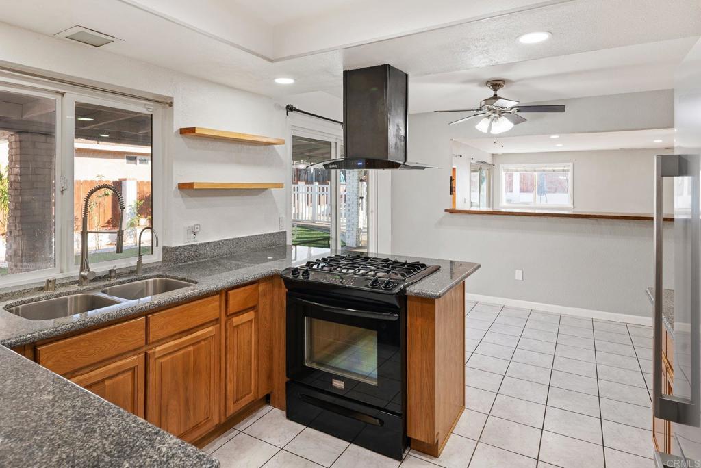 13131 Chrissy Way Lakeside, CA 92040 - Photo 16 of 30 a kitchen with stainless steel appliances granite countertop a stove a sink and a microwave