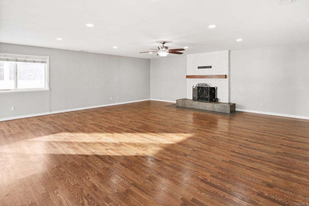 13131 Chrissy Way Lakeside, CA 92040 - Photo 8 of 30 a view of empty room with wooden floor and fireplace