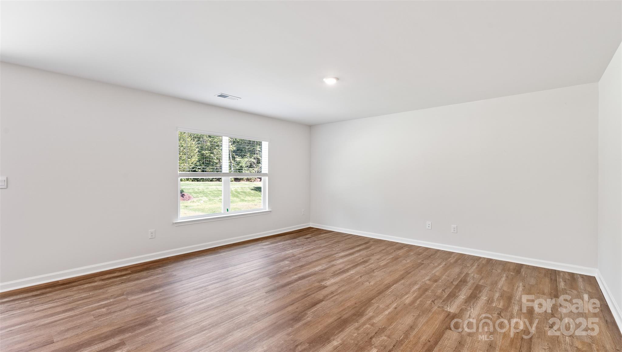 131 Bovine Br Road Fletcher, NC 28732 - Photo 12 of 31 an empty room with wooden floor and windows