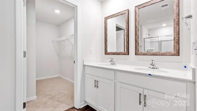 a bathroom with a double vanity sink mirror and