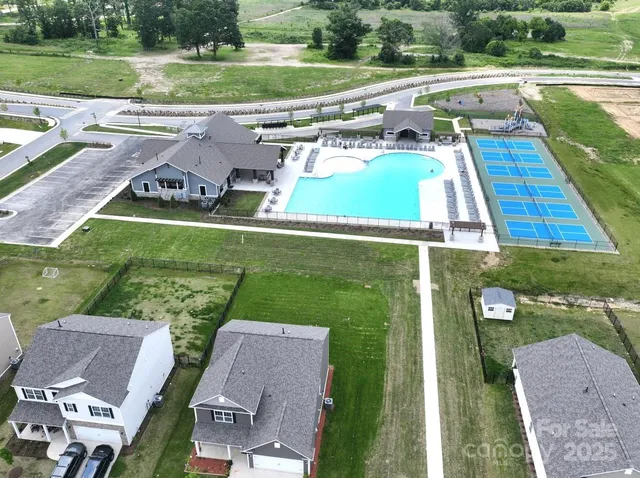 an aerial view of a house with a big yard