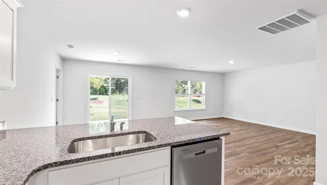 a kitchen with granite countertop a sink and a window