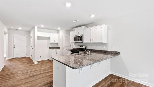 a kitchen with a sink stove and refrigerator