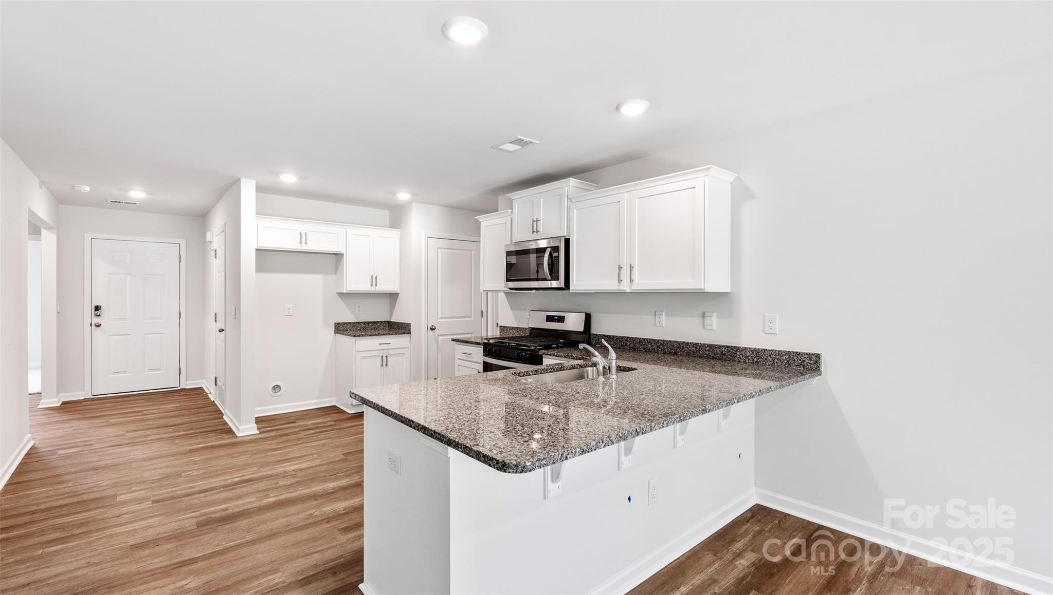131 Bovine Br Road Fletcher, NC 28732 - Photo 7 of 31 a kitchen with a sink stove and refrigerator