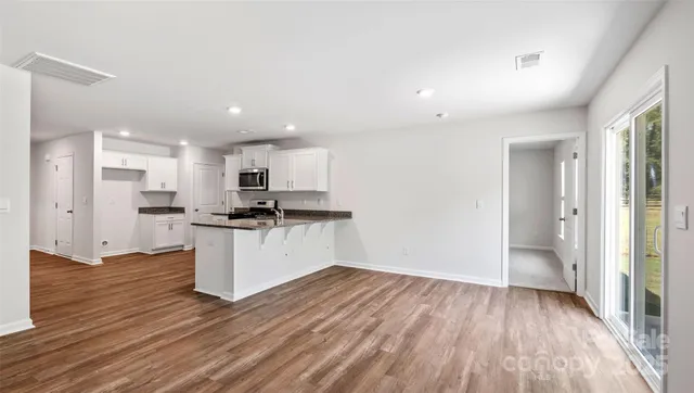 a view of kitchen with wooden floor