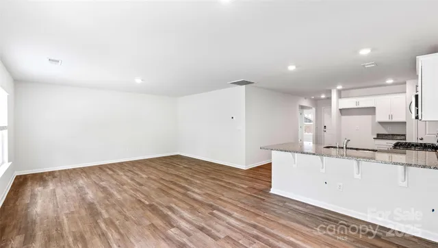 a kitchen with granite countertop a sink and cabinets