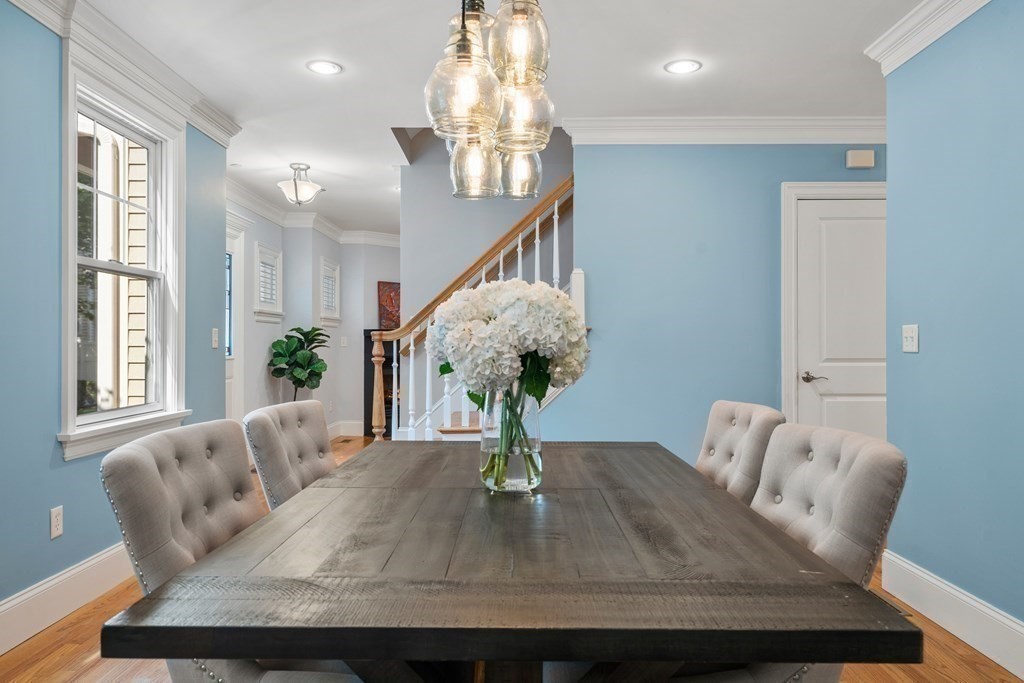 96 Crescent Street, Unit 96 Newton, MA 02466 - Photo 11 of 36 a living room with furniture and a chandelier