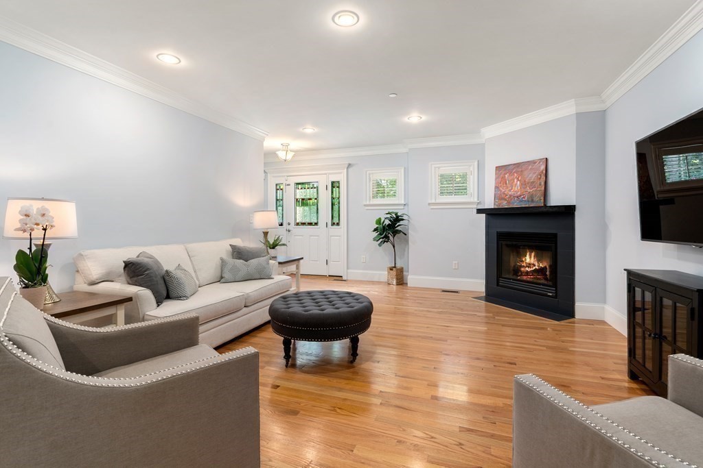 96 Crescent Street, Unit 96 Newton, MA 02466 - Photo 12 of 36 a living room with furniture a fireplace and a flat screen tv